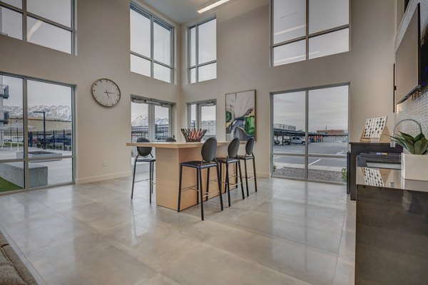 Modern clubhouse with pool table and plush seating at Harmony3900 Apartments, ideal for social gatherings and relaxation