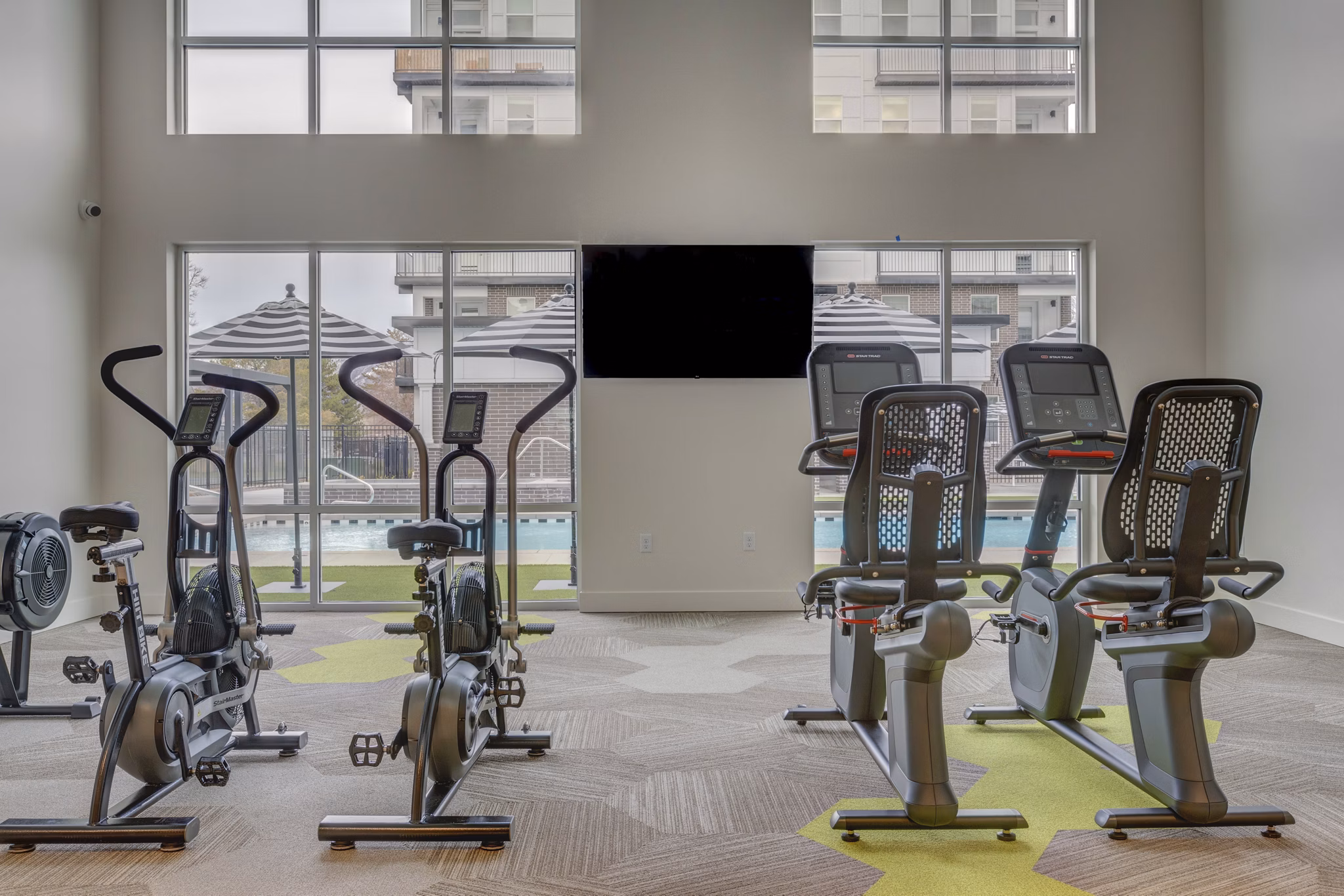State-of-the-art fitness center equipped with modern exercise machines at Harmony3900 Apartments
