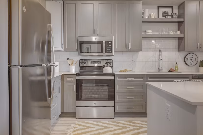 Harmony3900 Apartments: Modern kitchen design with stainless steel appliances and granite countertops in luxury apartment community