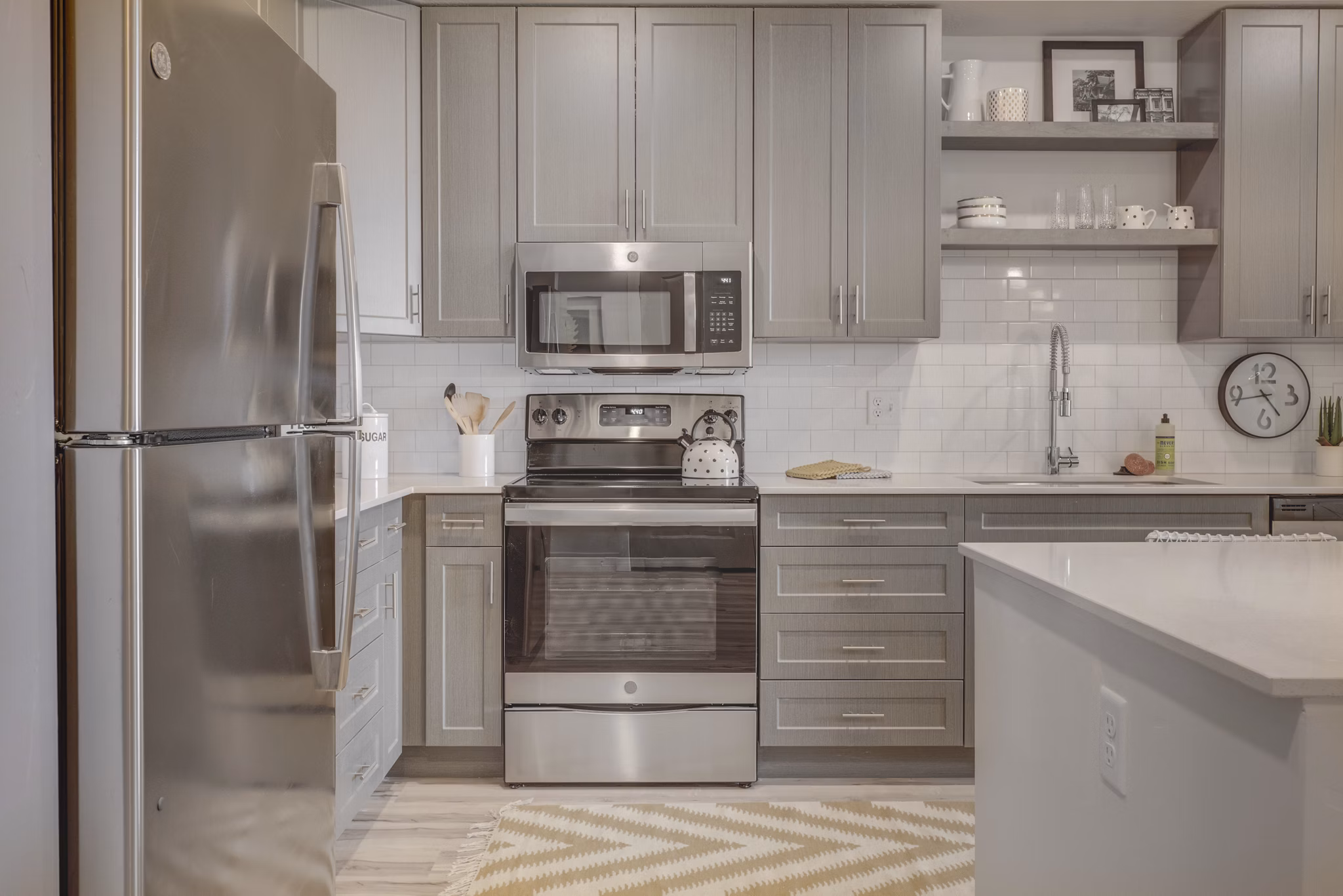 Harmony3900 Apartments: Modern kitchen design with stainless steel appliances and granite countertops in luxury apartment community