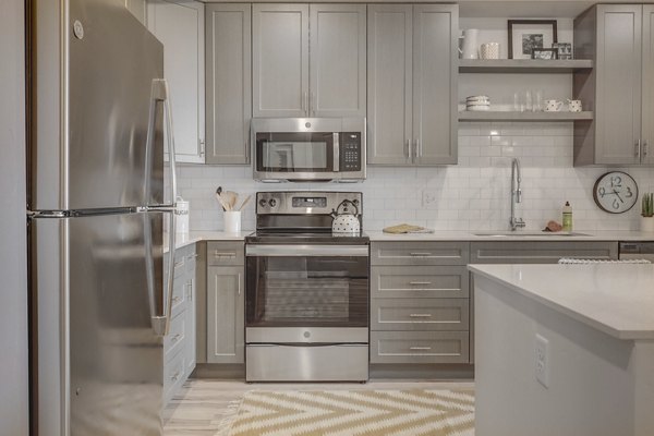 Harmony3900 Apartments: Modern kitchen design with stainless steel appliances and granite countertops in luxury apartment community
