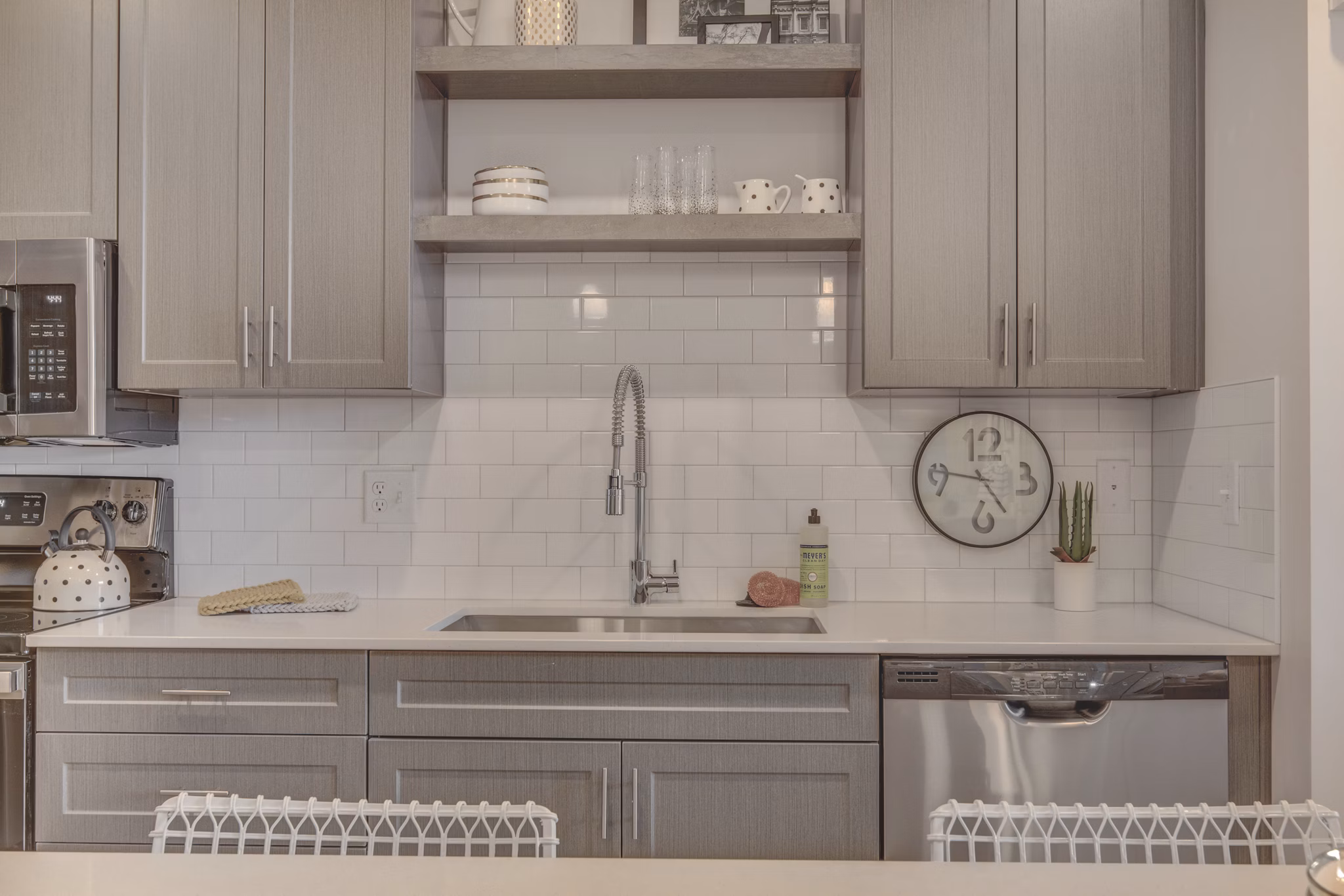 Kitchen featuring modern appliances and granite countertops in Harmony3900 Apartments