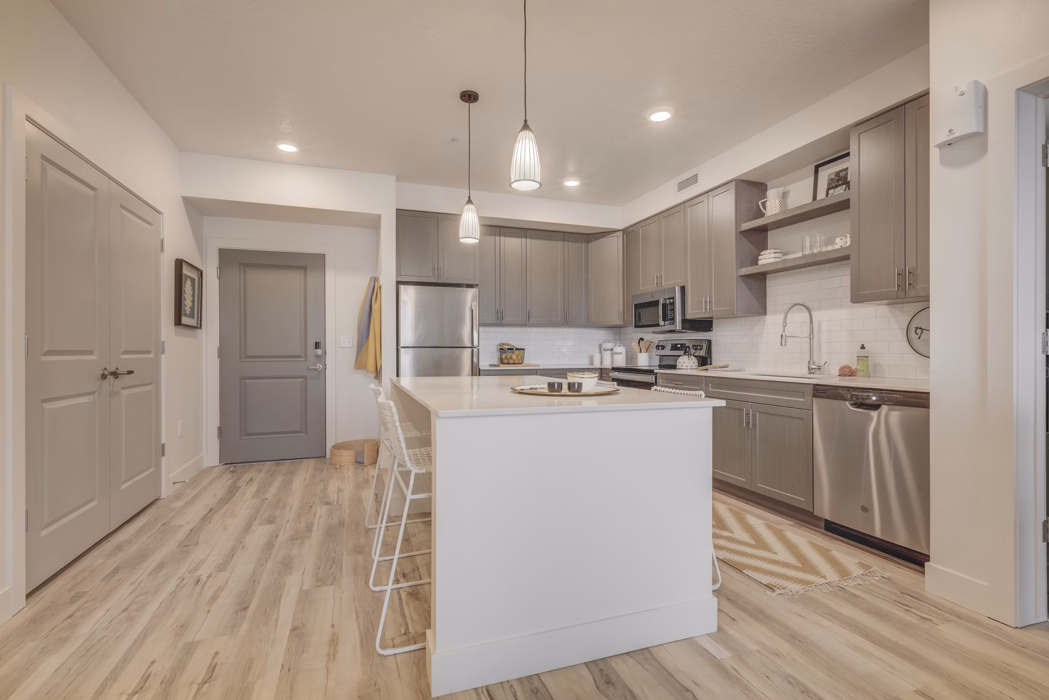 Modern kitchen with stainless steel appliances at Harmony3900 Apartments luxury complex