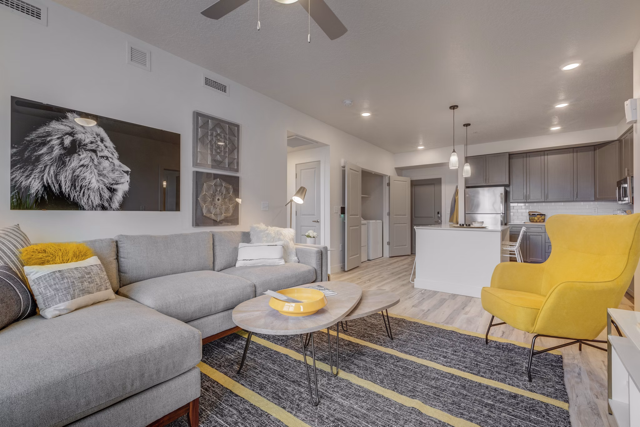 Modern living room with hardwood floors and stylish furniture in Harmony3900 Apartments