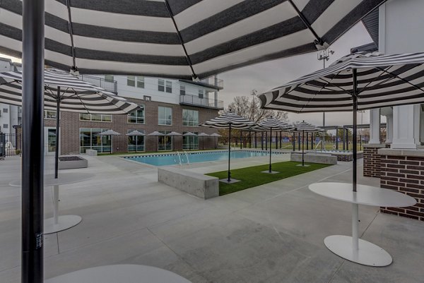 Harmony3900 Apartments: Resort-style pool area with sun loungers and lush landscaping