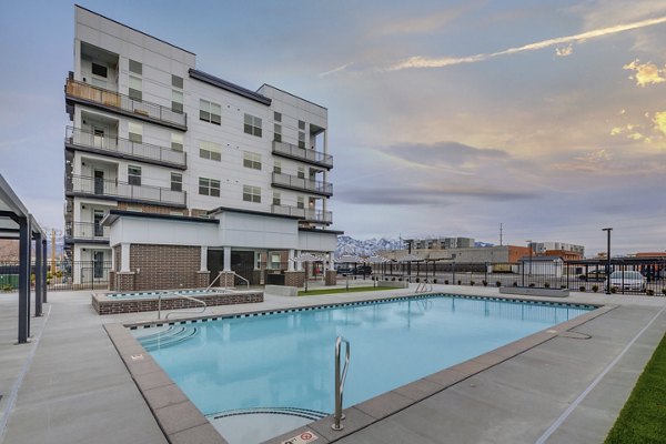 Rooftop pool with skyline views at Harmony3900 Apartments