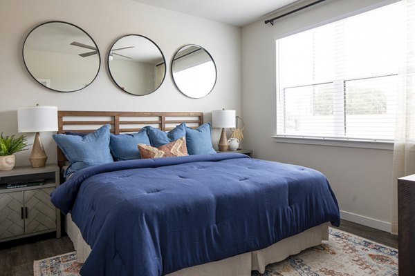 Modern bedroom featuring minimalist design and natural light at Bellrock Memorial Apartments