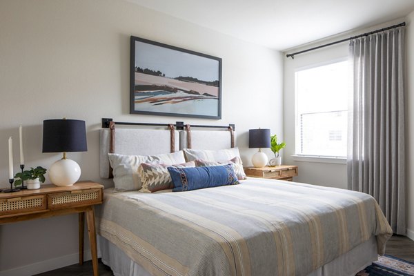 Cozy bedroom with modern furnishings at Bellrock Memorial Apartments