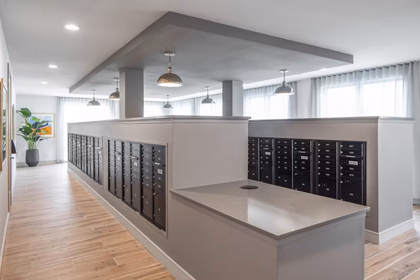 Clubhouse mail room with organized mail slots and modern design at Bellrock Memorial Apartments, providing convenient package handling for residents