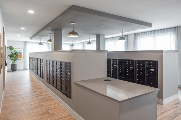 Clubhouse mail room with organized mail slots and modern design at Bellrock Memorial Apartments, providing convenient package handling for residents