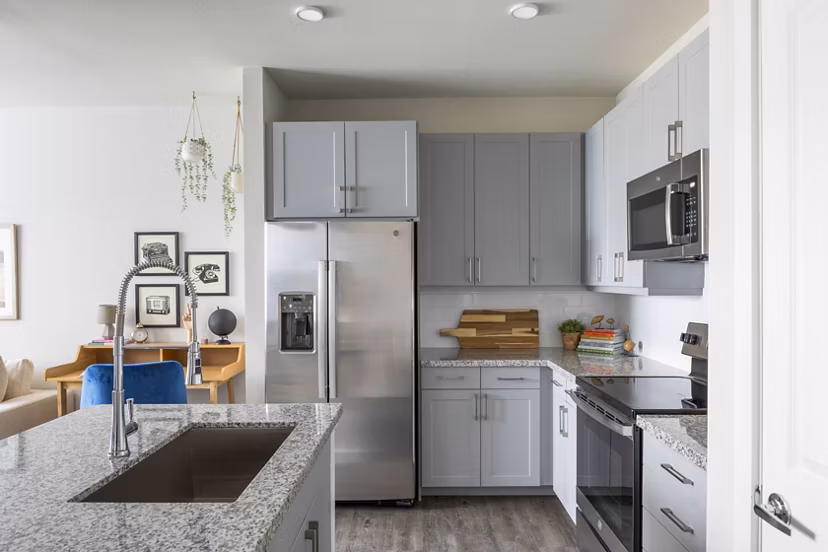 Modern kitchen featuring stainless steel appliances and granite countertops at Bellrock Memorial Apartments
