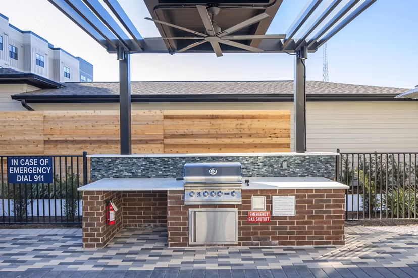 Outdoor patio with modern grill area at Bellrock Memorial Apartments