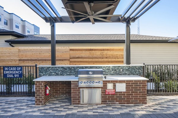 Outdoor patio with modern grill area at Bellrock Memorial Apartments