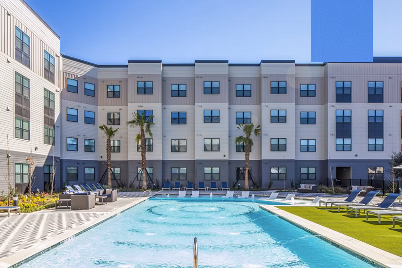 Resort-style pool with lounge chairs at Bellrock Memorial Apartments in Houston