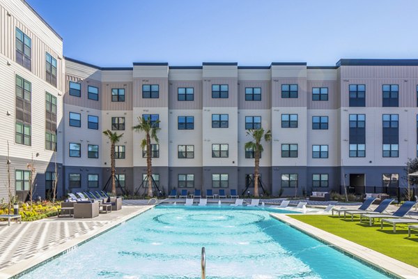Resort-style pool with lounge chairs at Bellrock Memorial Apartments in Houston