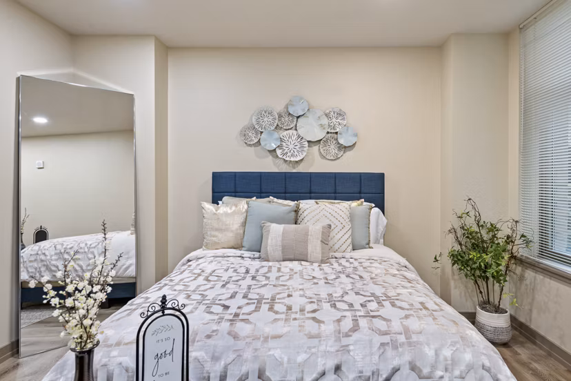 Cozy bedroom with modern furnishings at City Creek Landing Apartments, luxury living in the heart of the city