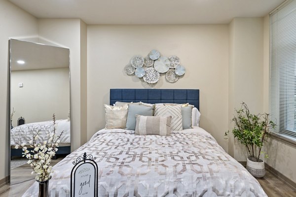 Cozy bedroom with modern furnishings at City Creek Landing Apartments, luxury living in the heart of the city