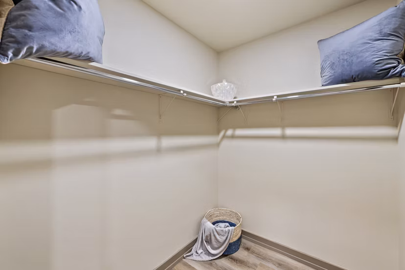 Walk-in closet with ample shelving in City Creek Landing Apartments