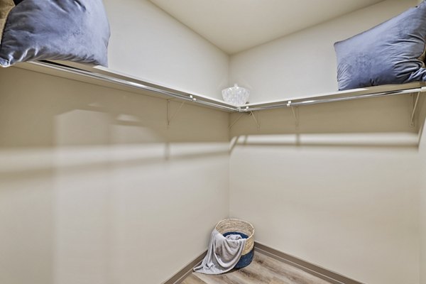 Walk-in closet with ample shelving in City Creek Landing Apartments