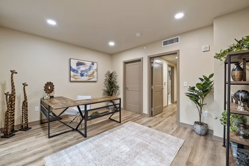 Bright home office with large desk and ergonomic chair at City Creek Landing Apartments, perfect for remote work and productivity