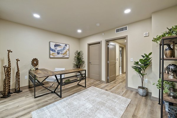 Bright home office with large desk and ergonomic chair at City Creek Landing Apartments, perfect for remote work and productivity