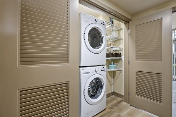 Laundry room with modern appliances in City Creek Landing Apartments