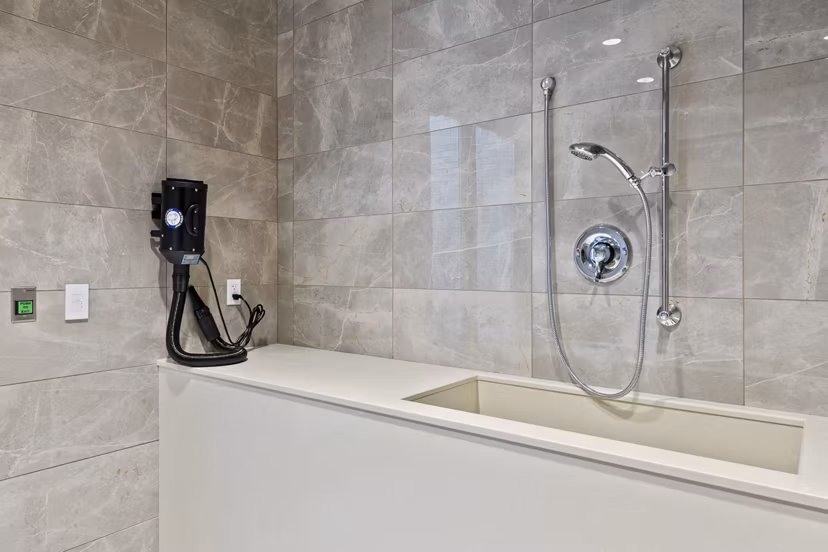 A modern dog wash station with tiled walls at City Creek Landing Apartments, perfect for pet-friendly living in Greystar's luxury community
