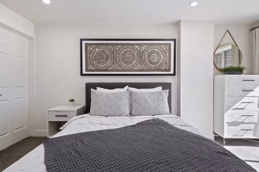 Cozy bedroom with plush bedding and modern decor at Brigham Apartments
