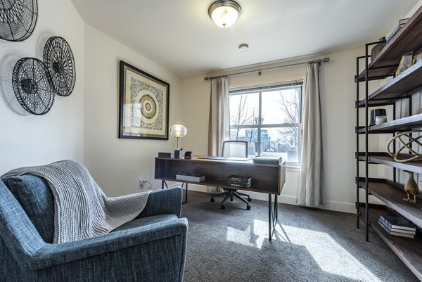 Bright bedroom with modern decor and large windows at Brigham Apartments