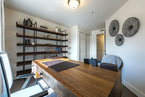 Bedroom with modern design and plush bedding at Brigham Apartments