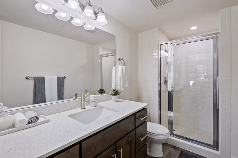 Modern bathroom featuring sleek fixtures at Brigham Apartments