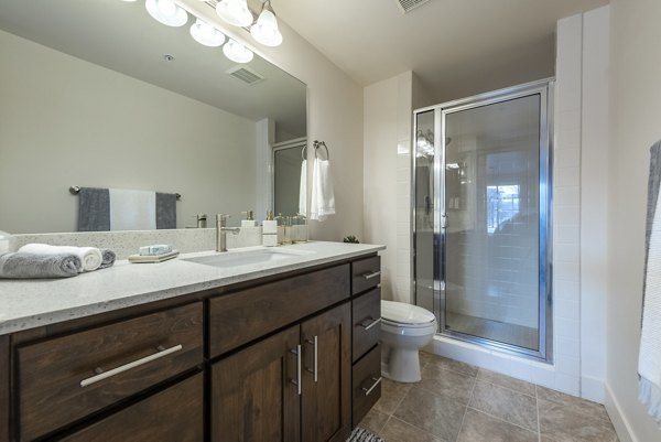 Modern bathroom featuring sleek fixtures at Brigham Apartments