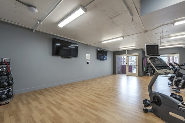 Yoga and spin studio featuring modern equipment at Brigham Apartments