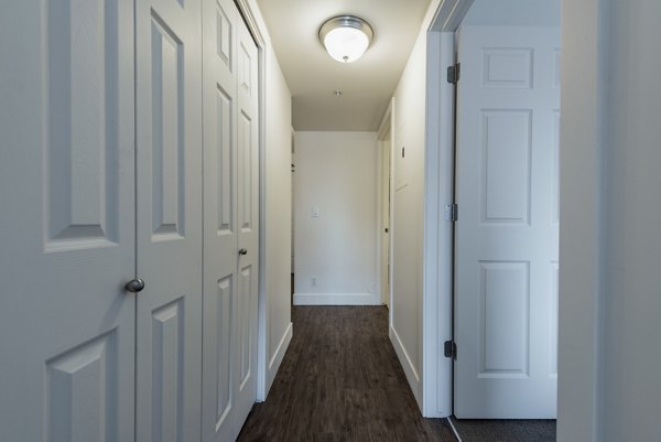 Hallway featuring contemporary design and modern lighting in Brigham Apartments