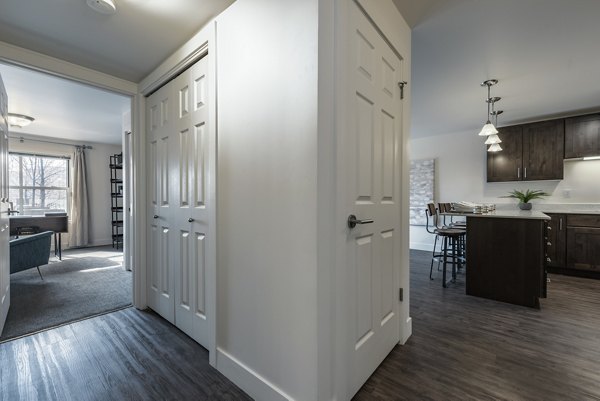 Elegant hallway with contemporary lighting and decor at Brigham Apartments, a luxury living community