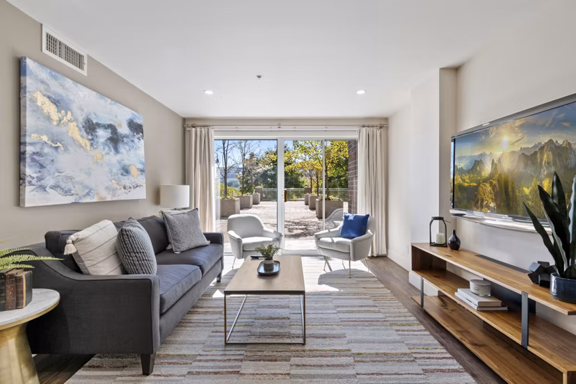 Spacious living room featuring modern decor and natural light at Brigham Apartments