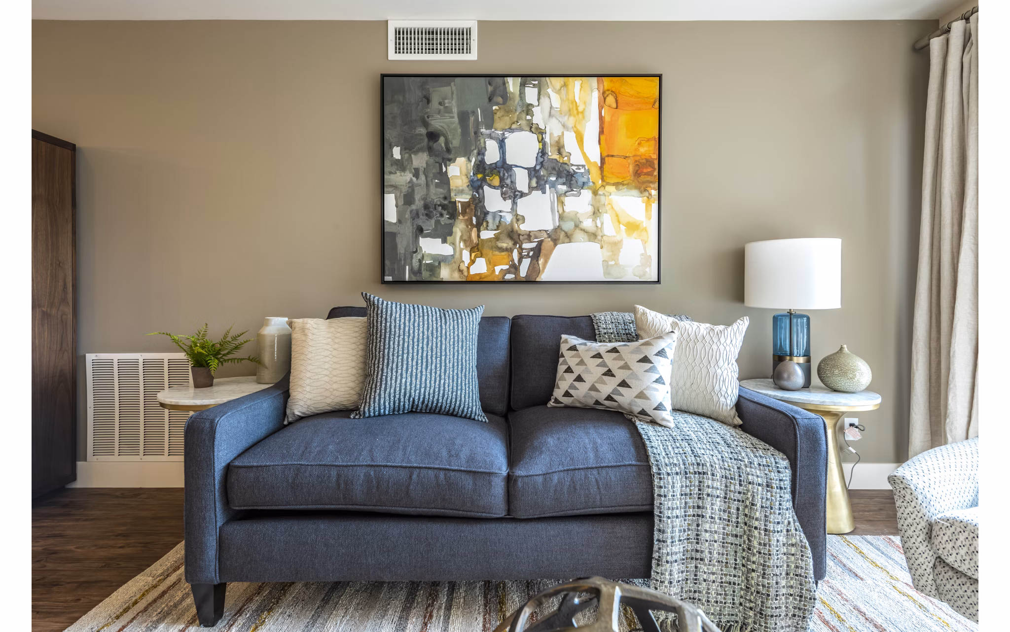 Bright living room with modern furnishings at Brigham Apartments, luxury spaces perfect for comfortable urban living