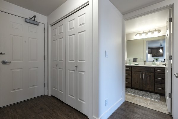 Laundry room featuring high-efficiency washers and dryers at Brigham Apartments
