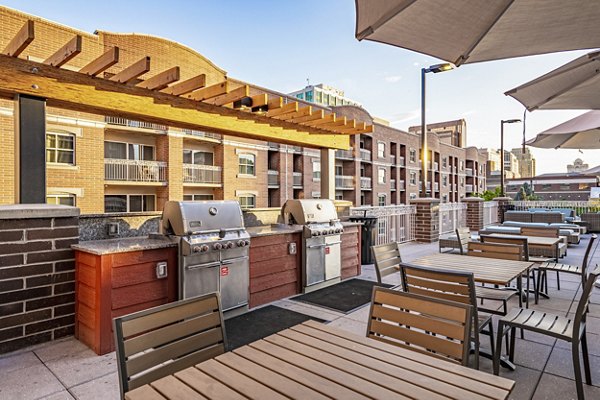 Outdoor grill area for residents at Brigham Apartments, offering a spacious setting for social gatherings and alfresco dining experiences