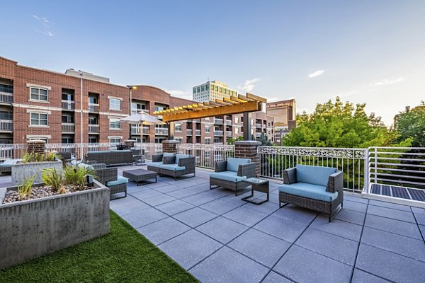 Courtyard featuring landscaped gardens at Brigham Apartments, offering luxury outdoor relaxation space