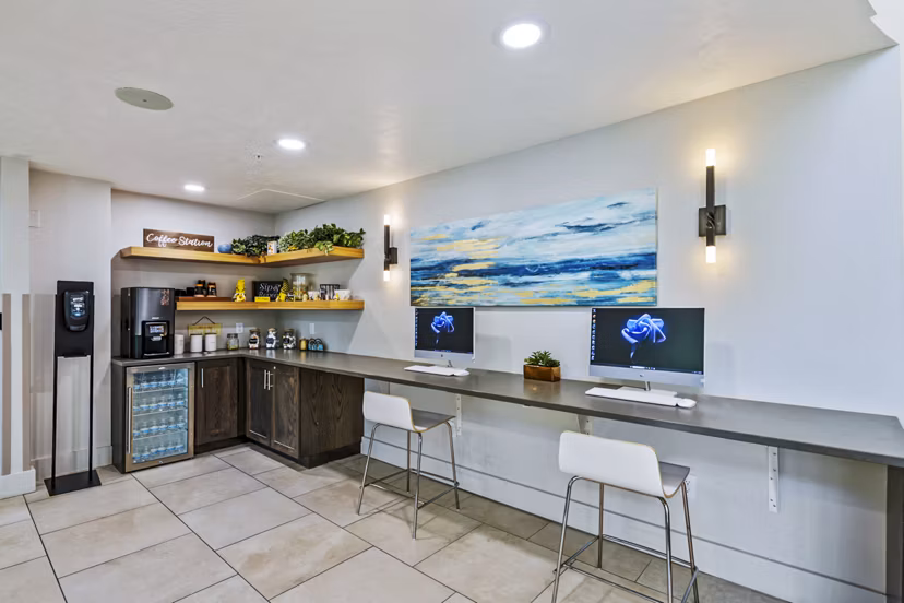 Modern meeting space with sleek seating in the clubhouse business center at Colonial Court Apartments