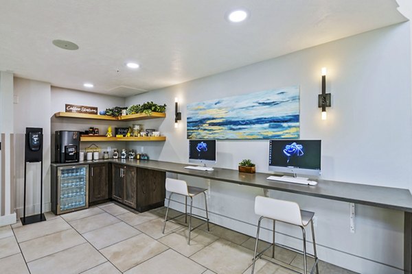 Modern meeting space with sleek seating in the clubhouse business center at Colonial Court Apartments