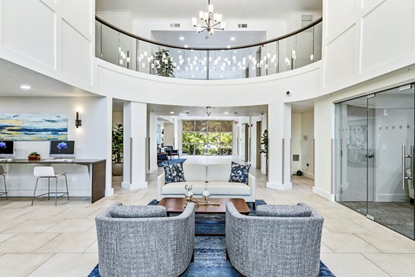 Clubhouse lobby with modern decor in Colonial Court Apartments, featuring elegant lighting and comfortable seating