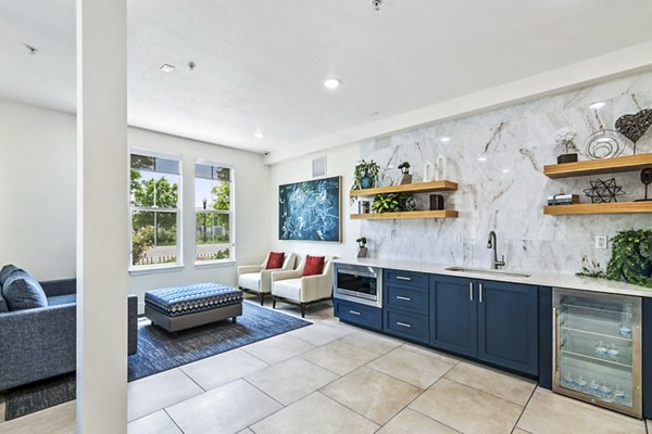 Clubhouse kitchen featuring modern appliances and ample seating at Colonial Court Apartments