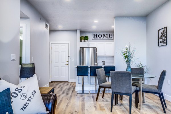 Dining room with elegant wooden table and chairs in Colonial Court Apartments