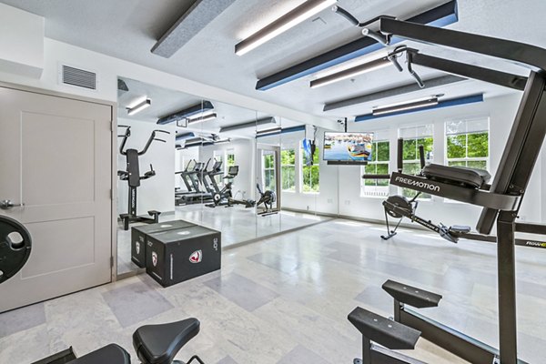 State-of-the-art fitness center at Colonial Court Apartments with cardio machines and weights for residents' health and wellness