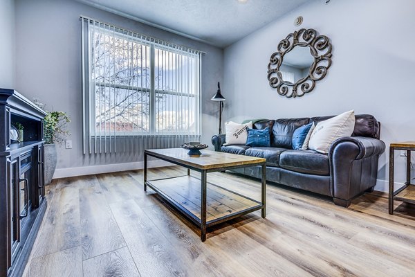 Spacious living room with modern decor in Colonial Court Apartments