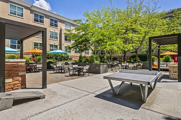 Grill area with modern seating in recreational space at Colonial Court Apartments