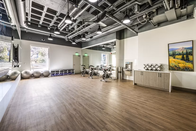Bright yoga and spin studio with large mirrors at Eagle Gate Apartments, a luxury community by Greystar located in the heart of the city