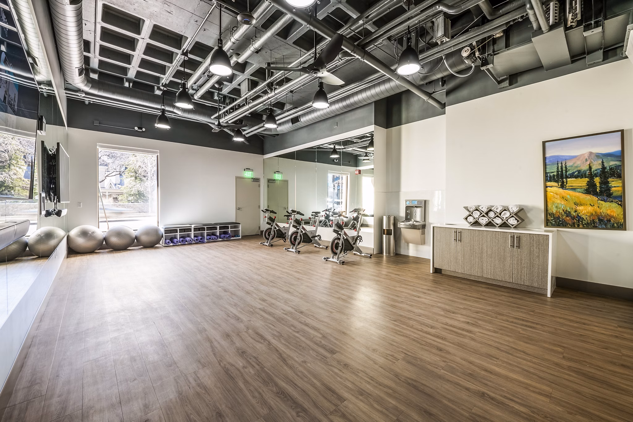 Bright yoga and spin studio with large mirrors at Eagle Gate Apartments, a luxury community by Greystar located in the heart of the city